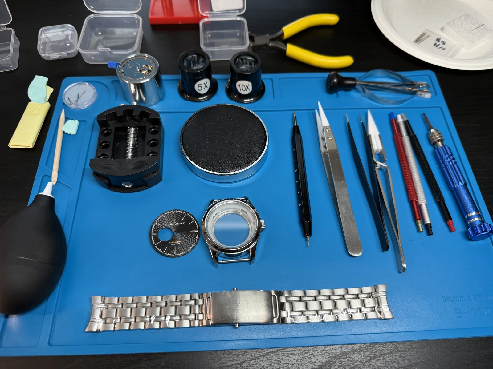 Watchmaking parts and tools on the workbench